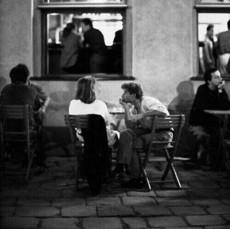 black and white photograph of people sitting at tables