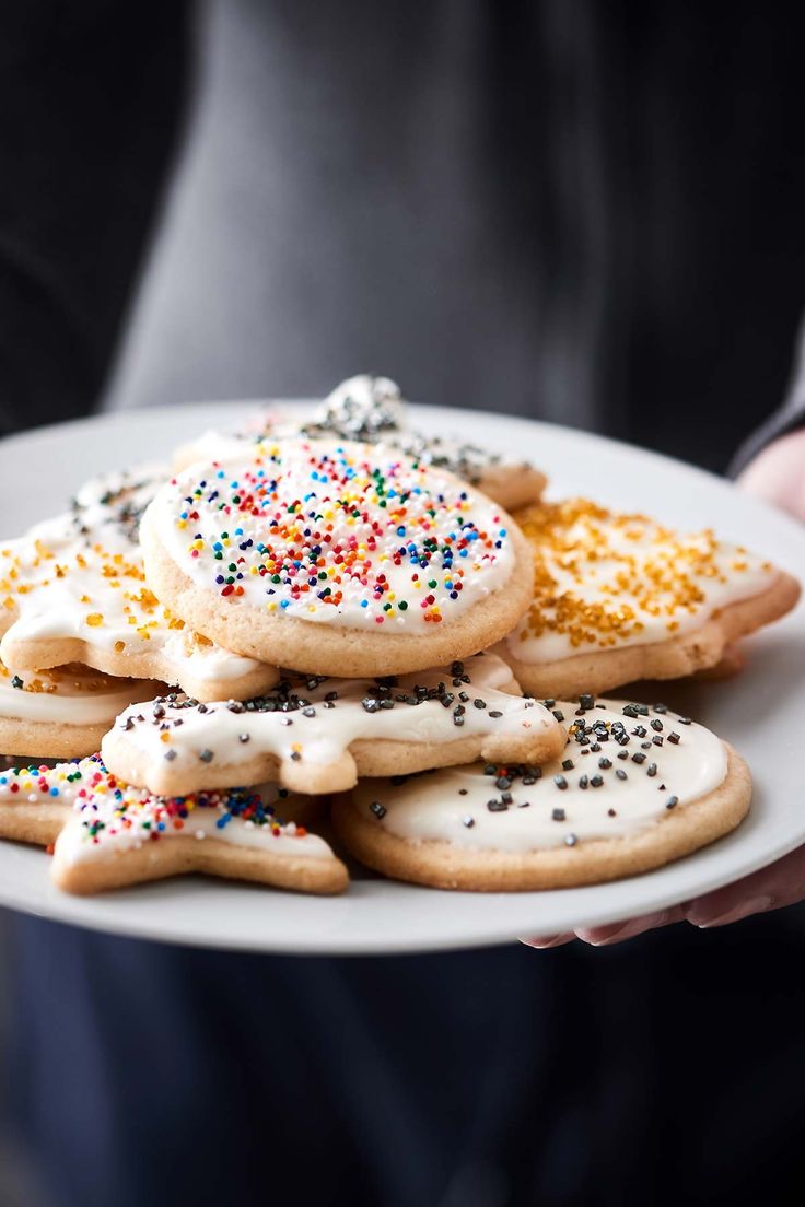 a white plate topped with cookies covered in sprinkles