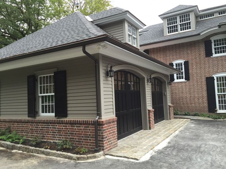 a brick house with black shutters and windows