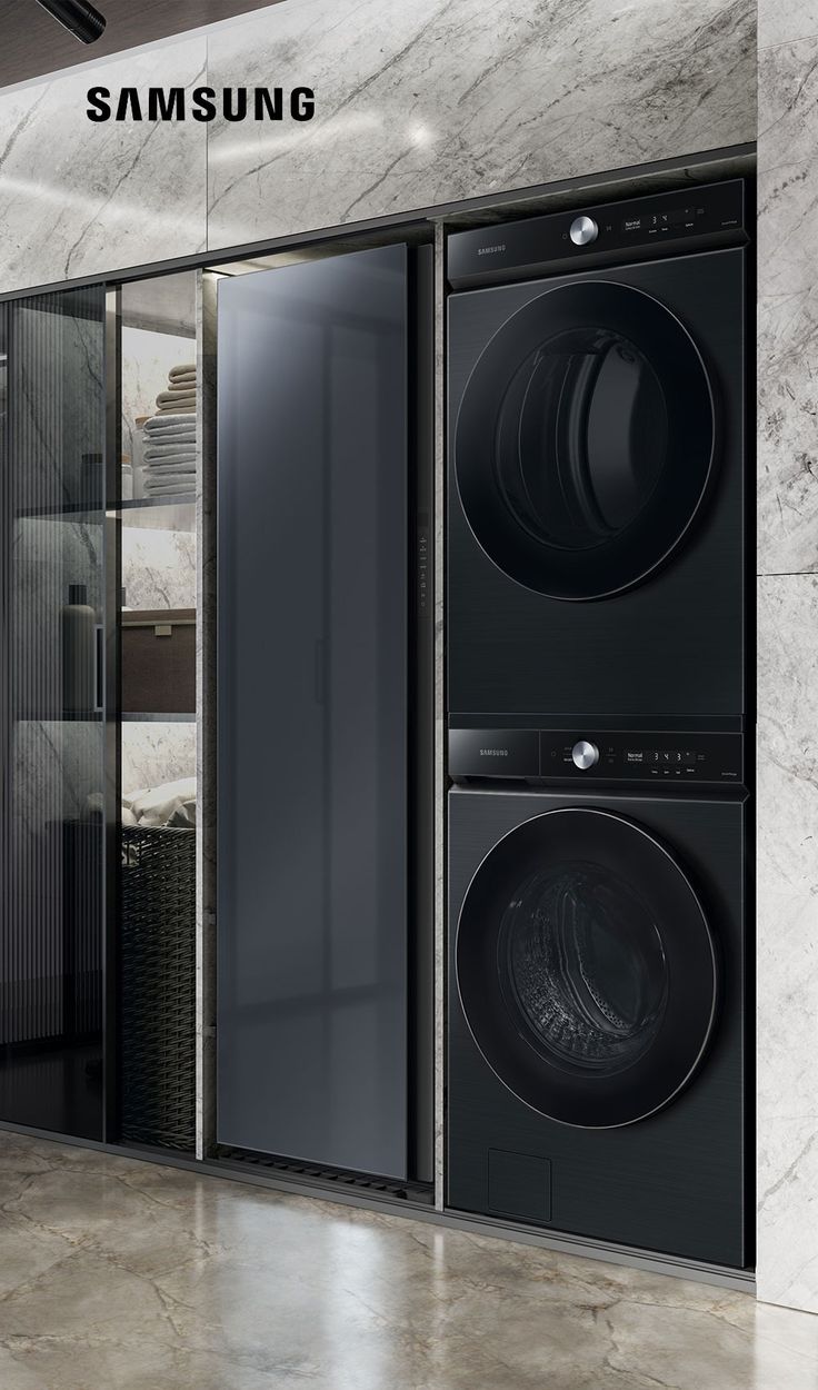 the samsung washer and dryer are next to each other in a room with marble walls