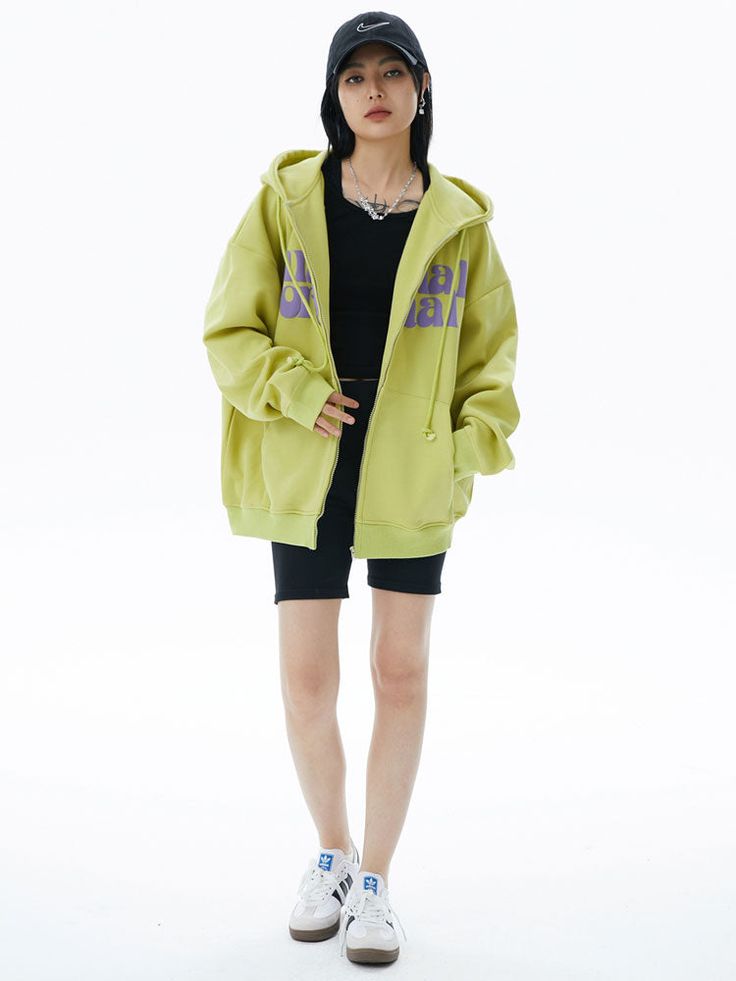 Make a bold statement with our Lime Green Graphic Zip Hoodie. This eye-catching sweatshirt features a vibrant lime green base with contrasting purple text across the chest. The playful typography design includes quirky eye graphics, adding a unique touch. With a comfortable fit, full-zip front, and kangaroo pockets, this hoodie combines style and practicality. Perfect for those who love standout streetwear with a fun twist, it's ideal for casual outings or lounging in style. The hoodie's bright Oversized Green Hoodie For Streetwear, Green Hooded Sweatshirt For Streetwear, Green Cotton Hoodie For Streetwear, Green Cotton Hip Hop Hoodie, Green Hooded Sweatshirt With Logo Print, Green Oversized Hoodie Sweatshirt, Oversized Green Urban Sweatshirt, Green Long Sleeve Hip Hop Hoodie, Casual Green Hoodie With Logo Print