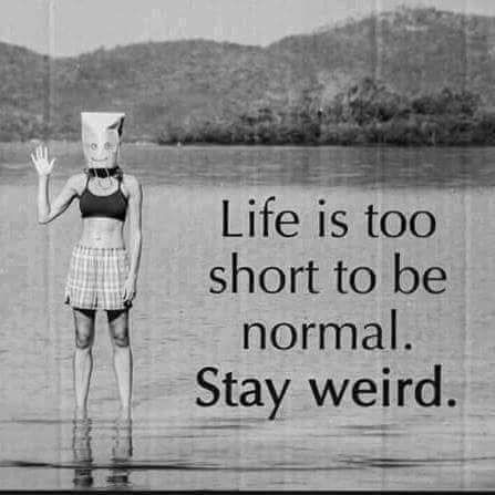 a woman standing in the water with a paper hat on her head and an ad that says life is too short to be normal stay weird