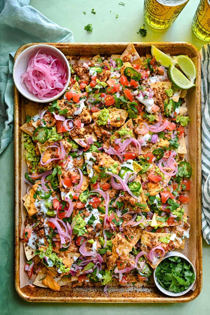 a tray filled with nachos, onions and salsa