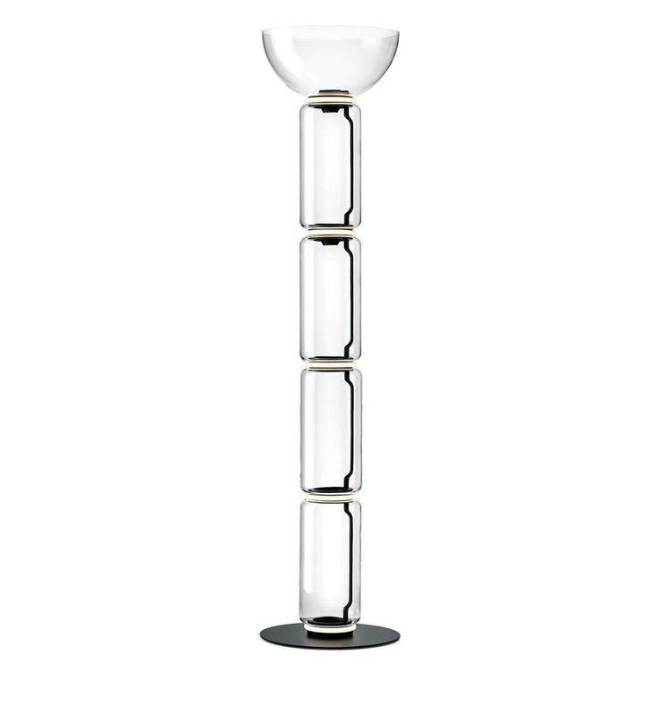 a tall glass vase sitting on top of a table