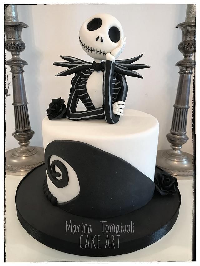 a decorated cake with a skeleton on top