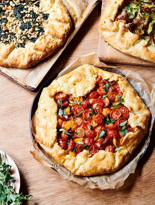 four different types of pizza on wooden boards