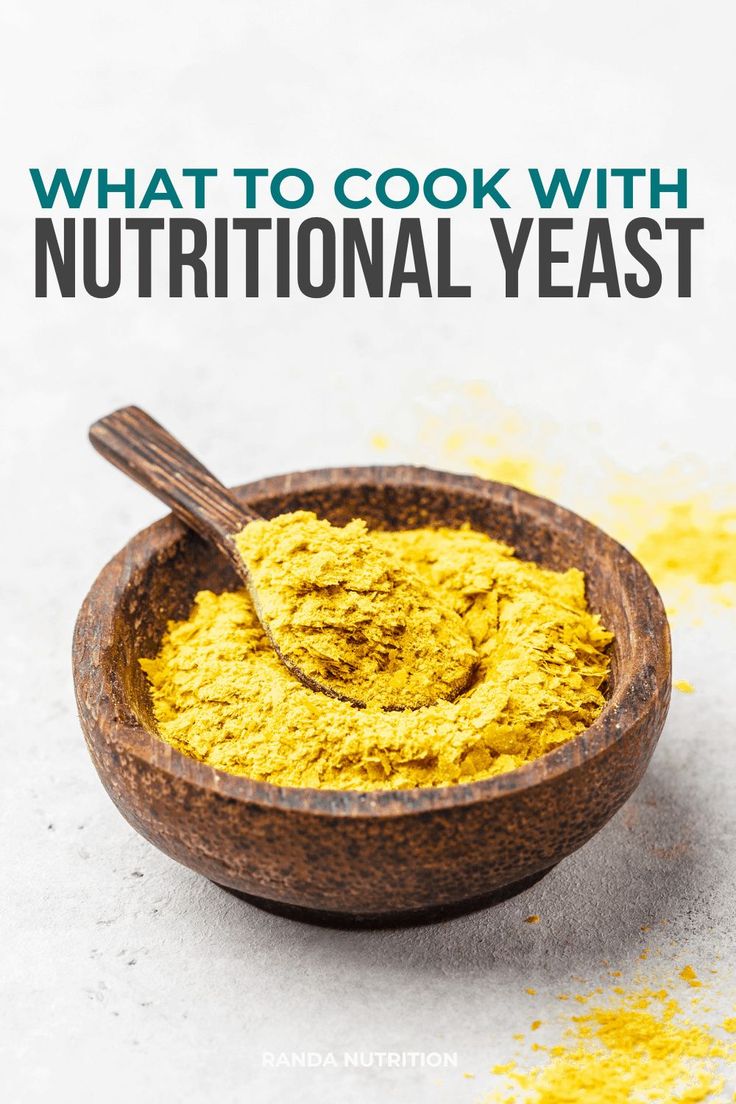 a wooden bowl filled with yellow powder and the words what is nutritional yeast?