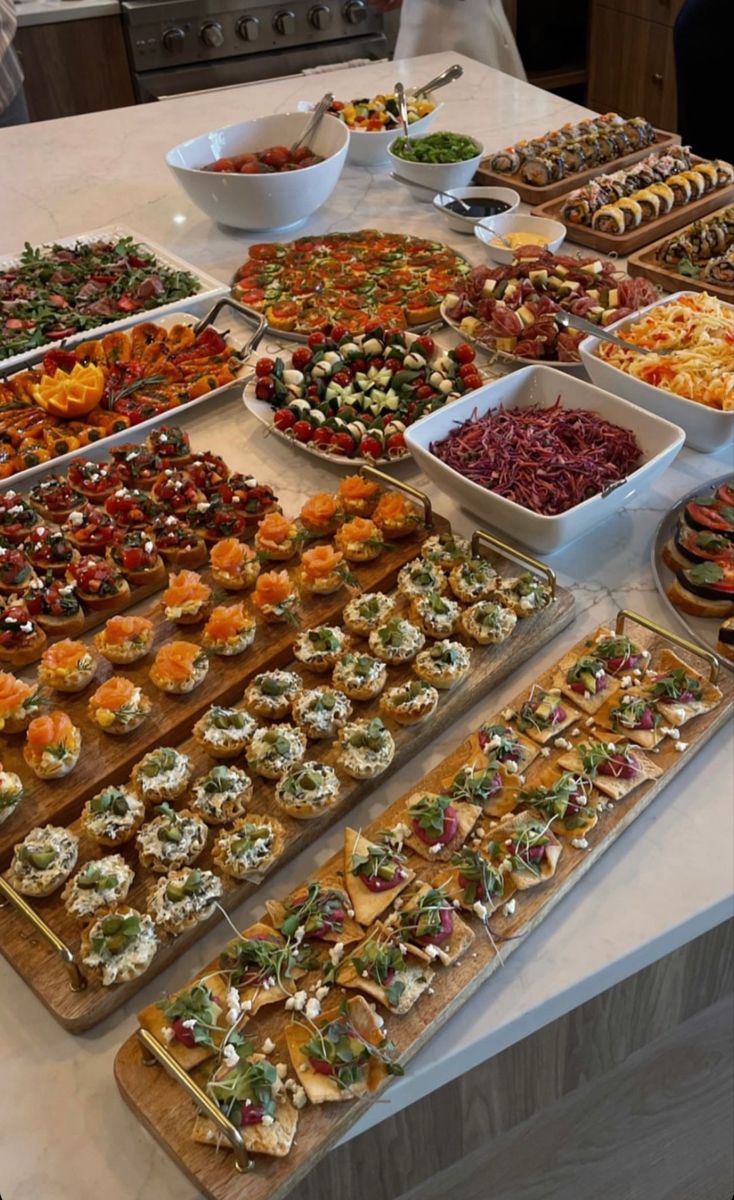 a table filled with lots of different types of food on it's trays