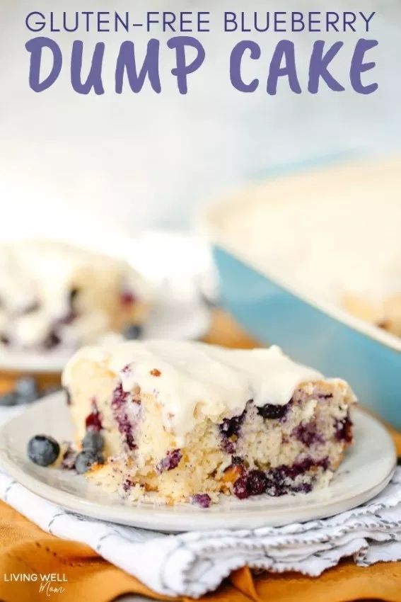 gluten - free blueberry dump cake on a plate with the rest of the cake in the background