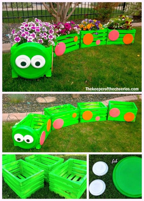 an outdoor play area made out of pallets and plastic crates with eyes on them