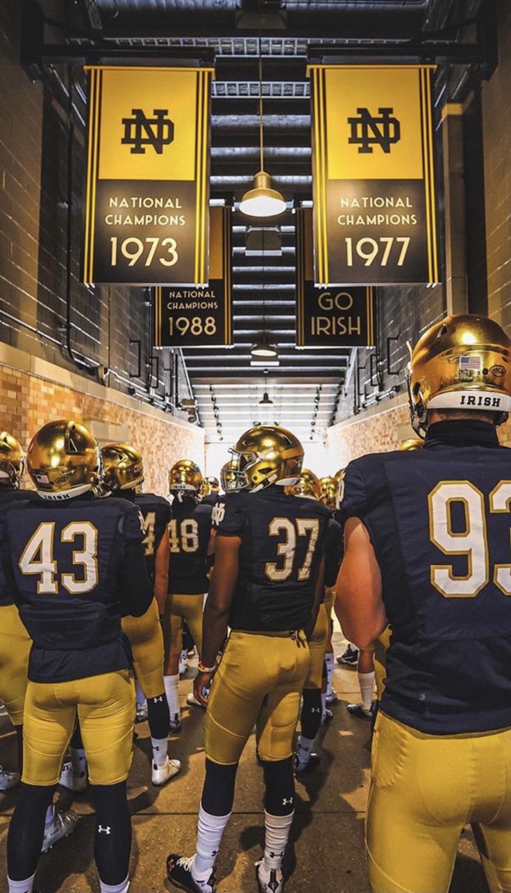 the football team is walking down the tunnel