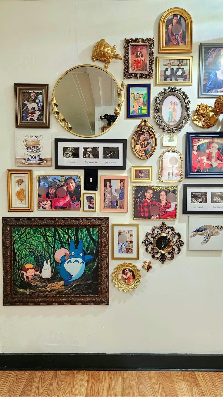 there are many pictures on the wall with mirrors and frames around them, all hanging up