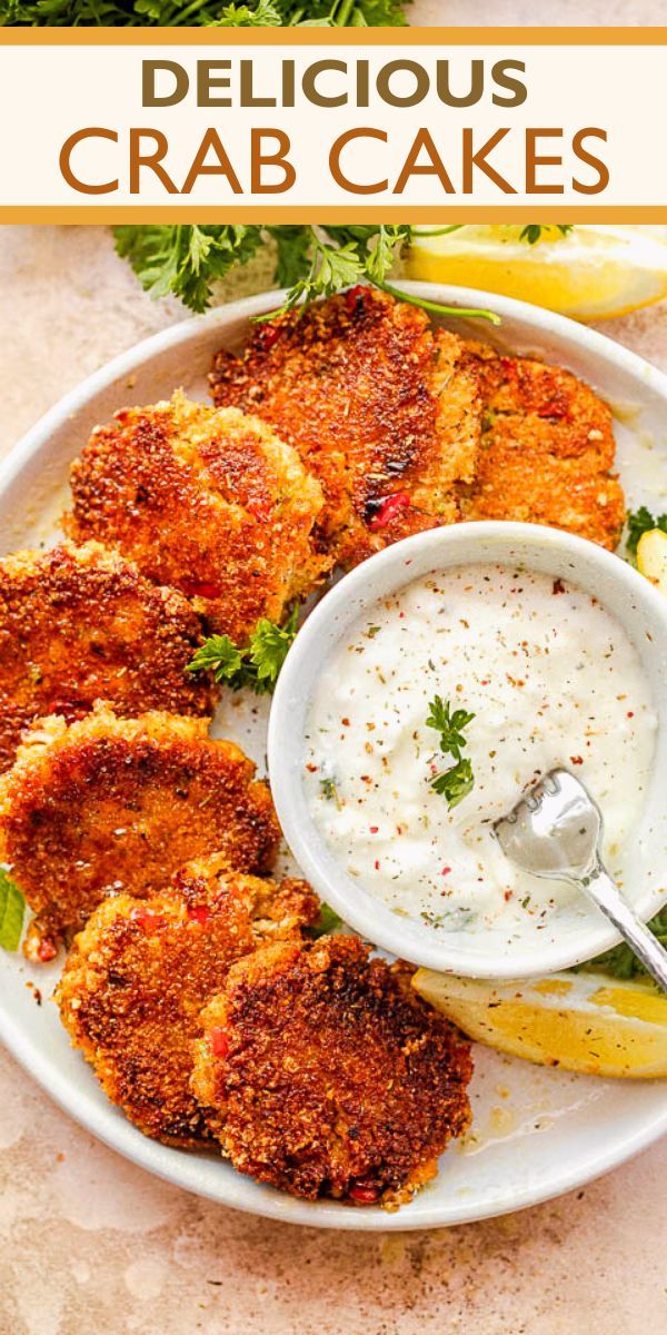 crab cakes on a plate with dipping sauce