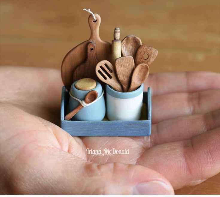 a miniature kitchen utensils in a blue cup