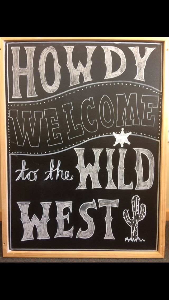 a chalkboard sign that says, howdy welcome to the wild west on it