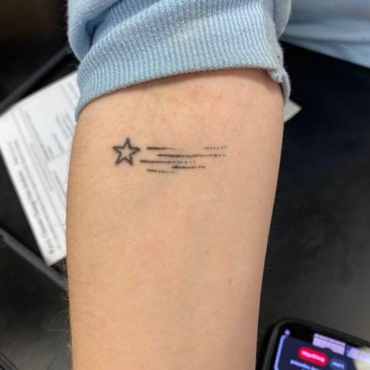 a person with a star tattoo on their arm