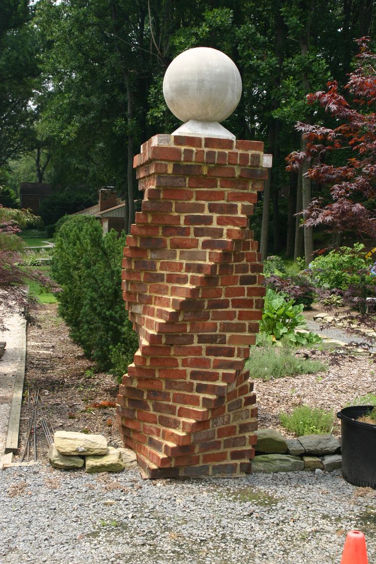 a brick structure with a white ball on top