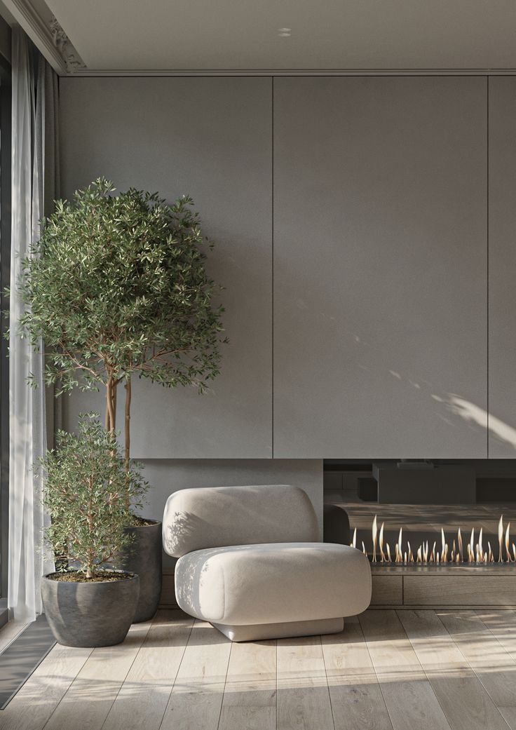 a living room with a couch, fireplace and potted tree in the corner next to it