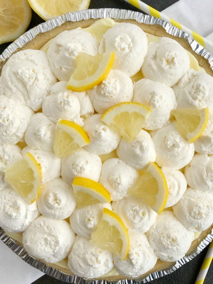 a pie with lemons and marshmallows on top is ready to be eaten