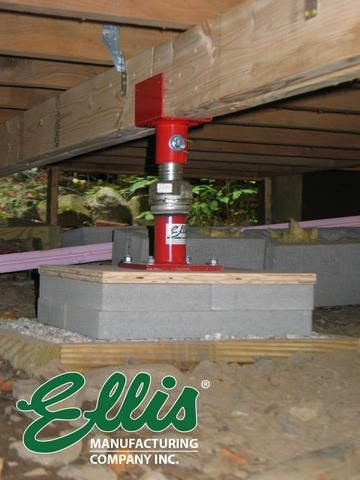 the inside of an unfinished building with wood beams and cement blocks in place for insulation