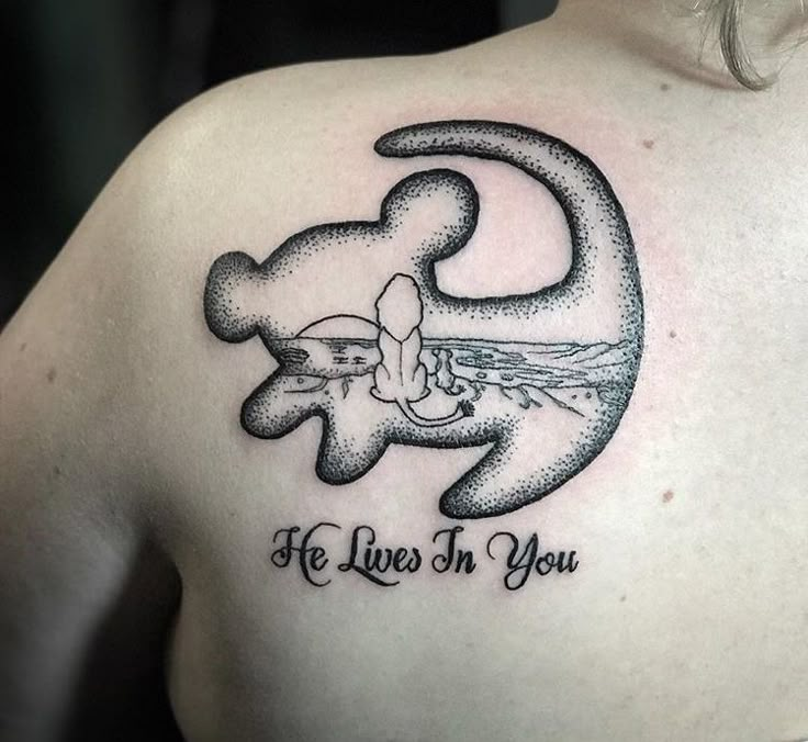 a man with a tattoo on his back that says he lives in you and an elephant