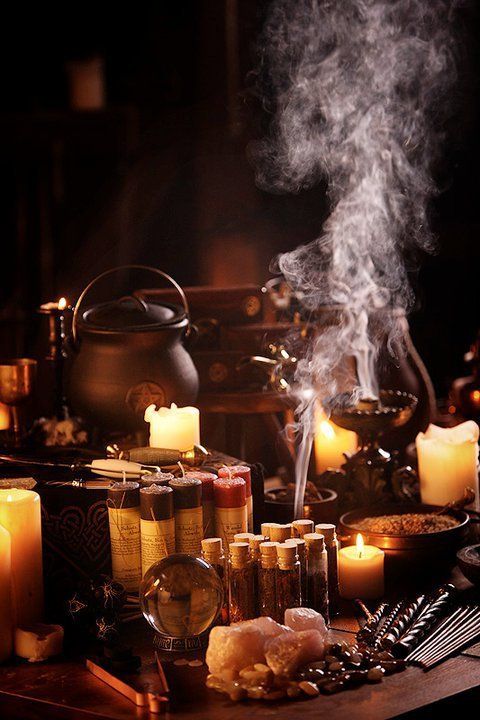 a table topped with lots of candles next to pots and pans filled with food