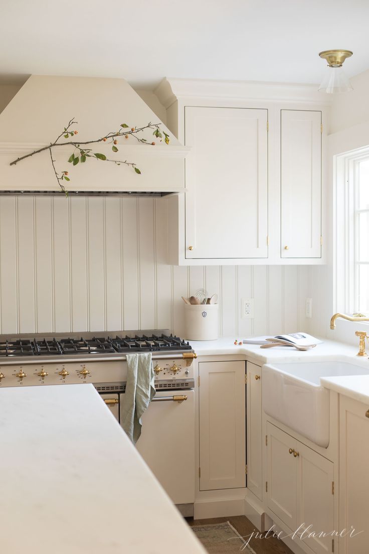 a kitchen with white cabinets and an oven