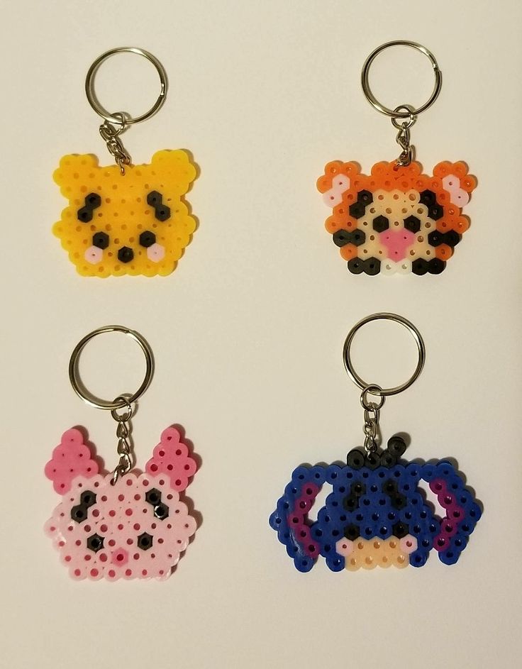 four key chains with different designs on them