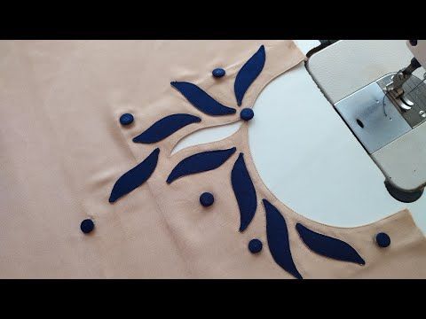 a machine is cutting fabric with blue flowers on it