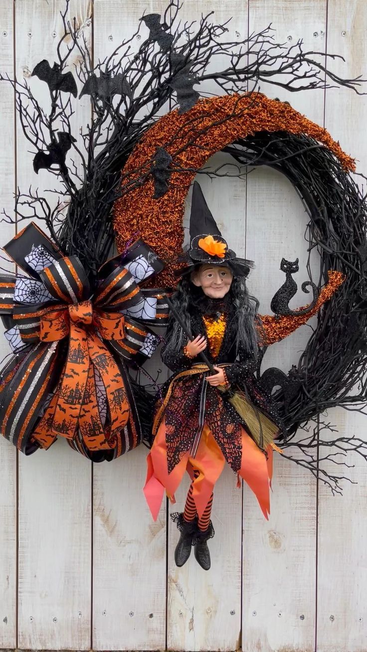 a halloween wreath with a witch doll on it