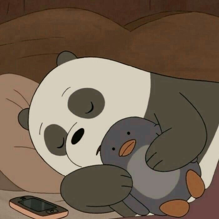 a panda bear hugging a stuffed animal on top of a bed next to a cell phone