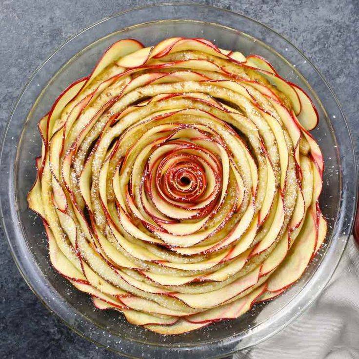 an apple pie is shown in a glass dish