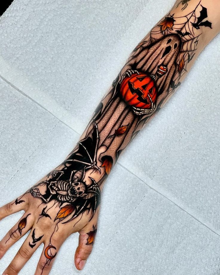 a person's hand with a tattoo on it and a pumpkin in the center