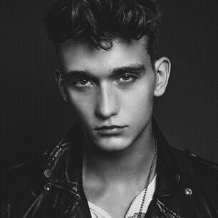 black and white photograph of a young man wearing a leather jacket