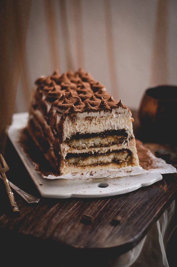 there is a cake that has been cut in half on the plate and ready to be eaten