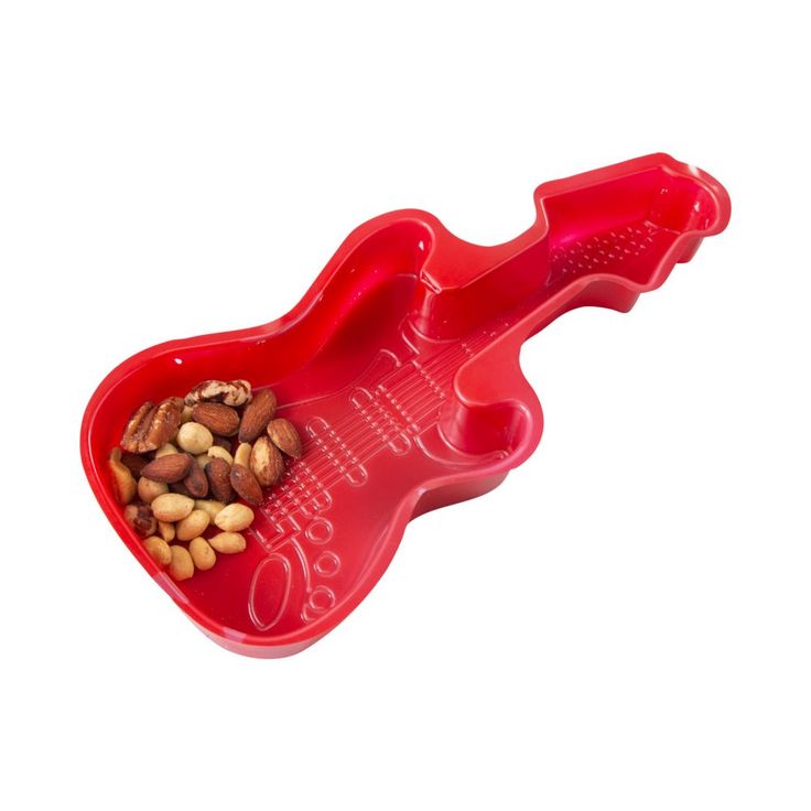 a red plastic guitar shaped bowl filled with nuts and other things to eat in it