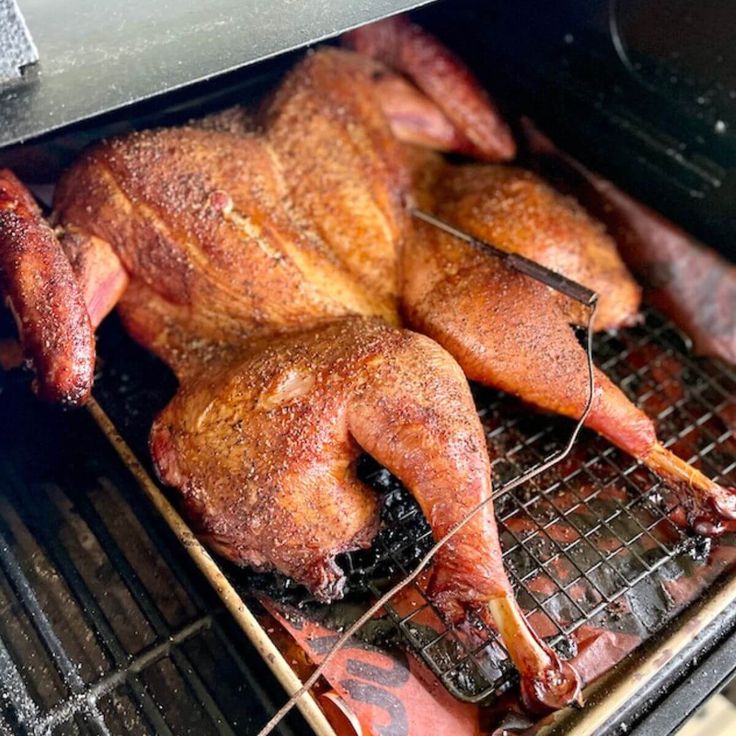 a chicken is being cooked on the grill