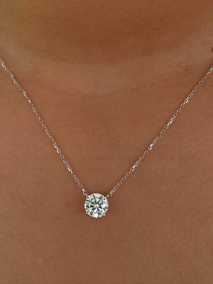 This Beautiful timeless floating prong set diamond pendant is set with 3-carat lab-grown diamond in 14k solid gold. It will be the classic perfect gift for any woman in your life--whether she's your wife, girlfriend, fiancée, or bride. The pendant and chain are made of 14k solid gold and feature a spring clasp. The necklace is available for purchase with or without an IGI certificate. All of our diamonds are high-quality D color, VS1 clarity. Each diamond is securely set in a Prong setting, radiating sophistication with every glance. Every diamond is expertly positioned to reflect maximum light and brilliance that tells your forever love story. Item Details: 14k solid gold pendant and chain Chain length: 16 inches up to 18 inch Diamond: CVD lab-grown diamonds  Total Weight :3 carats Cut: R Luxury Refined Solitaire Necklace With Brilliant Cut, Luxury Dazzling Diamond Necklace With Prong Setting, Luxury Cushion Cut Necklace With Prong Setting, Delicate Diamond Solitaire Necklace With Round Pendant, Simple Diamond Pendants Designs, Gold Round Lab Grown Diamond Solitaire Necklace, Gold Solitaire Necklace With Round Lab Grown Diamond Pendant, Round Pendant Solitaire Necklace With Lab-grown Diamond, Lab Diamond Pendant Necklace Solitaire 1.5 Ct