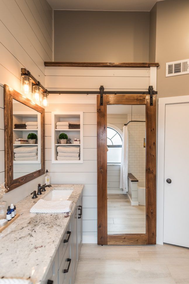 a bathroom with double sinks and two mirrors