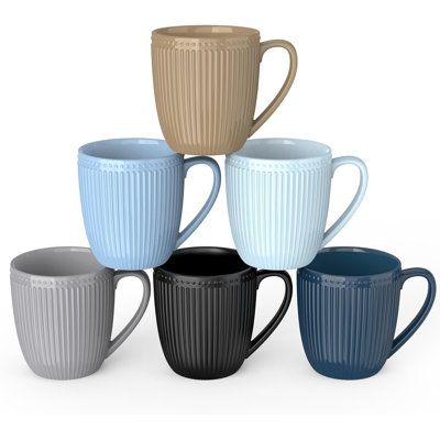 five different colored coffee mugs sitting next to each other