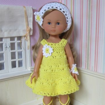 the doll is wearing a yellow dress with white flowers