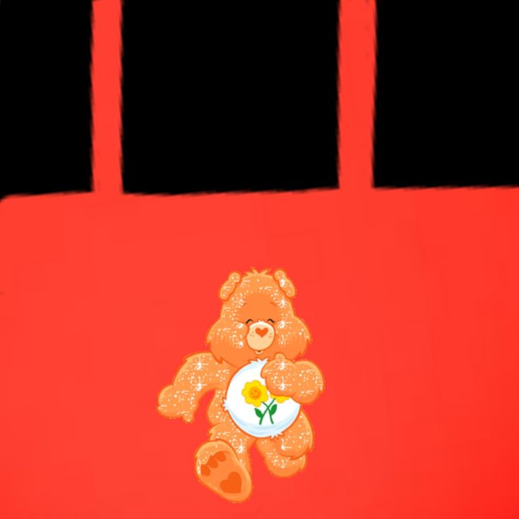 a brown teddy bear sitting on top of a red bag with a flower in it