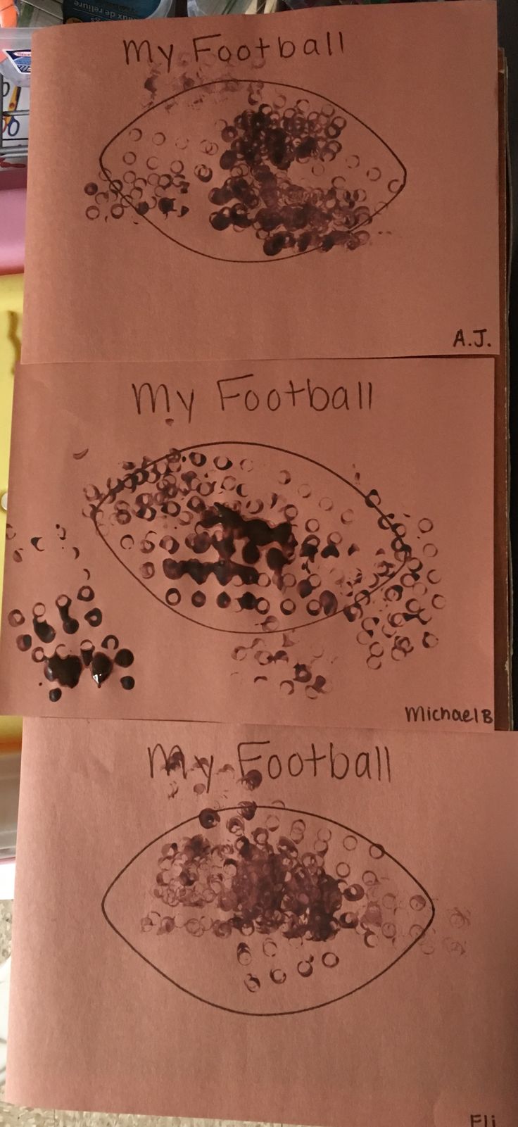 two pieces of brown paper with black ink on them that say my football and my football