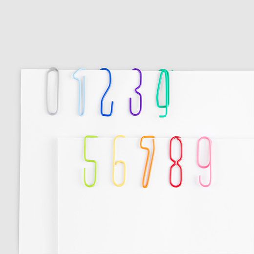 three different colored paper clips on top of each other with numbers written in the middle