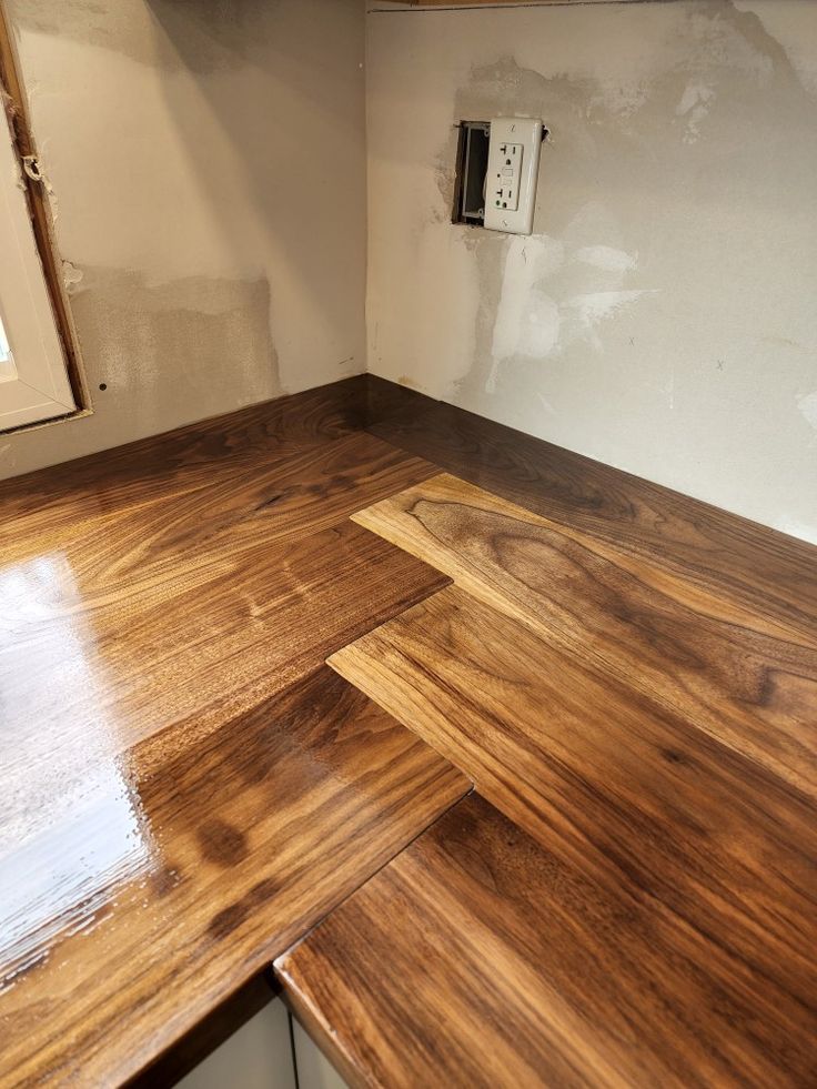 an unfinished kitchen counter with wood flooring