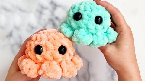 two small crocheted animals sitting next to each other