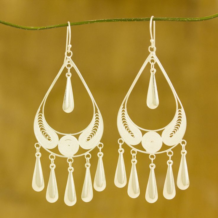 Leaves project their delicate beauty, laying trapped in silver raindrops. Their design is by Wararat Supasirisuk, who finds inspiration in the graceful artistry of Thai jewelry fashions. She crafts the earrings of sterling silver and accents the leaves with ornate filigree work. Sterling silver Hook earrings Handmade in & fairly-traded from Thailand Leaves Project, Thai Jewelry, Silver Chandelier Earrings, Quilled Jewellery, Kay Jewelry, September Birthstone Jewelry, Filigree Jewelry, Printed Jewelry, Filigree Earrings