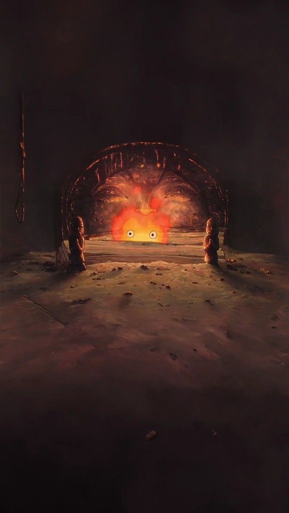 two people sitting on the ground in front of an open tunnel with fire coming from it