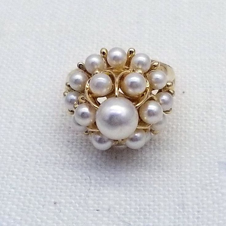 Vintage Mikimoto 14k Gold  Pearl Cluster Cocktail Ring Beautiful detailed Cocktail Cluster Ring, set with 19 Mikimoto Pearls, each measuring approx. 3.4-7mm.  Table Dimension is approximately 19mm x 19mm Hand crafted in 14 Karat Yellow Gold. The ring epitomizes vintage charm, taking you from day to evening effortlessly.  Comes with lacquered wood box Ring Condition is excellent.- Very clean surface, no marks or scratches visible  Pearl Condition is excellent - Round with an excellent luster.  No Classic White Jewelry Stamped 14k, Classic White 14k Stamped Jewelry, 14k Stamped Cluster Jewelry For Anniversary, White Cluster Ring Stamped 14k, Heirloom White Jewelry Stamped 14k, Classic White Cluster Ring Hallmarked, Timeless Gold Cluster Jewelry, Gold Cluster Fine Jewelry, Classic White Hallmarked Cluster Ring