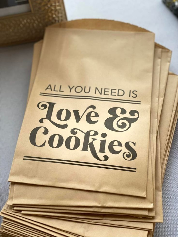 all you need is love and cookies paper bags stacked on top of eachother